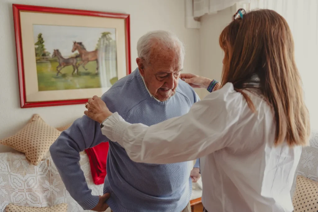 Team member assisting senior during respite care stay
